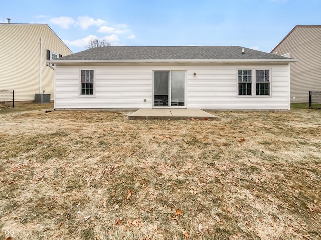 back of property with a patio area, a lawn, central AC, and fence