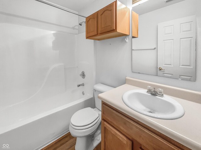 full bath with vanity, wood finished floors, visible vents, shower / bathing tub combination, and toilet