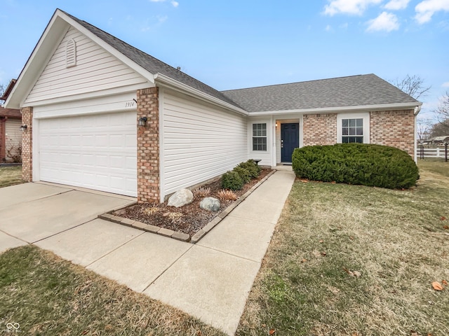 ranch-style house with a front yard, driveway, an attached garage, a shingled roof, and brick siding