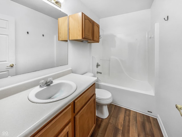 bathroom with bathing tub / shower combination, toilet, wood finished floors, and vanity