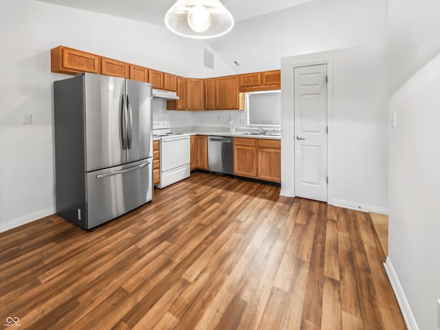 kitchen with dark wood-style floors, baseboards, stainless steel appliances, light countertops, and under cabinet range hood