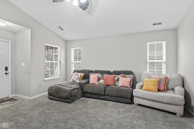 living area with visible vents, baseboards, lofted ceiling, and carpet