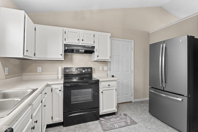 kitchen featuring black range with electric stovetop, under cabinet range hood, white cabinetry, freestanding refrigerator, and lofted ceiling