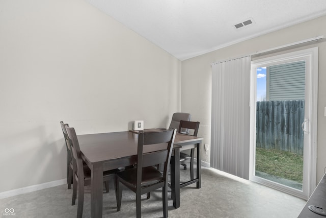 carpeted dining room featuring visible vents and baseboards