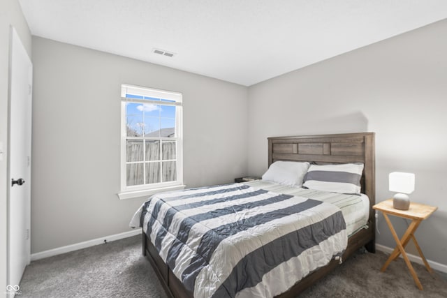 bedroom featuring visible vents, baseboards, and carpet