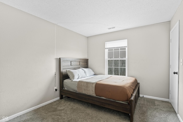 bedroom with visible vents, baseboards, carpet, and a textured ceiling