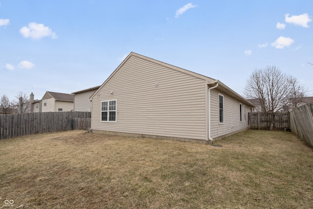 view of home's exterior featuring a yard and a fenced backyard