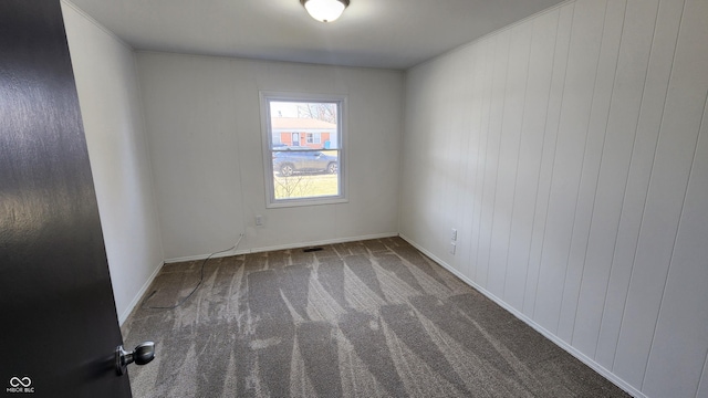 empty room with visible vents and carpet