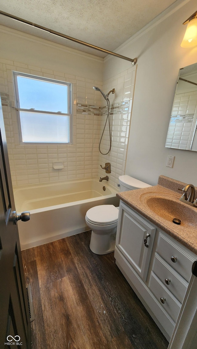 bathroom with vanity, shower / bath combination, wood finished floors, a textured ceiling, and toilet