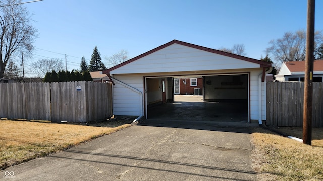 detached garage featuring fence