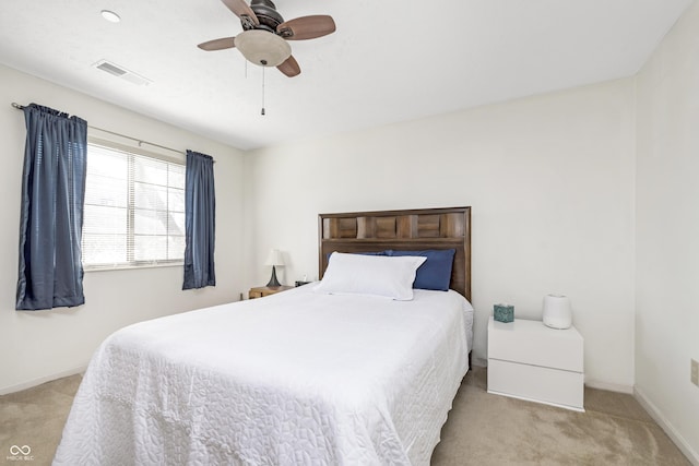 carpeted bedroom with baseboards, visible vents, and ceiling fan