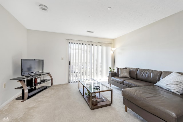 carpeted living area with visible vents and baseboards