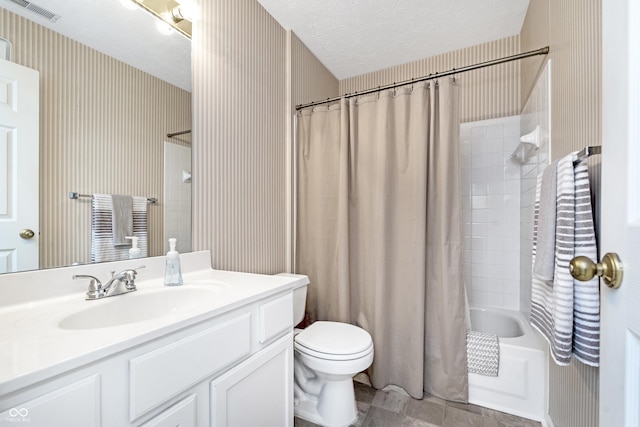 bathroom with vanity, wallpapered walls, shower / bath combo with shower curtain, a textured ceiling, and toilet