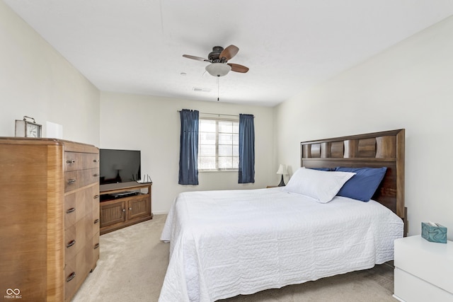 bedroom featuring visible vents, light carpet, and ceiling fan