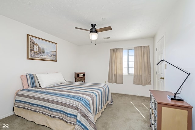 bedroom with ceiling fan, carpet, visible vents, and baseboards