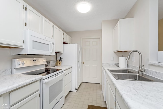 kitchen with white appliances, white cabinetry, a textured ceiling, and a sink