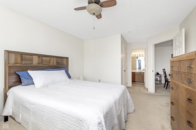 bedroom with connected bathroom, a ceiling fan, and light carpet