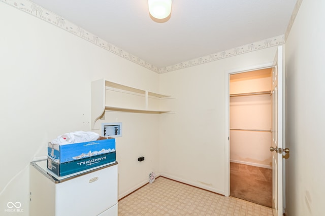 laundry area featuring laundry area, electric dryer hookup, baseboards, and washer hookup