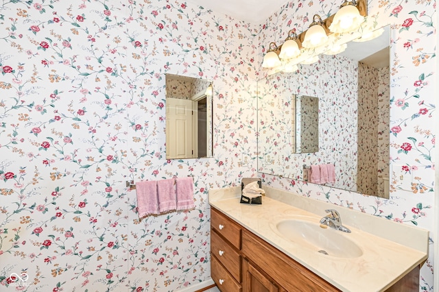 bathroom with wallpapered walls and vanity