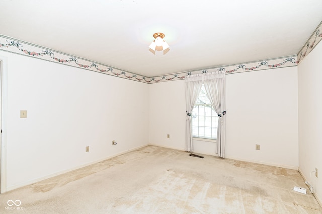 spare room with light carpet and visible vents