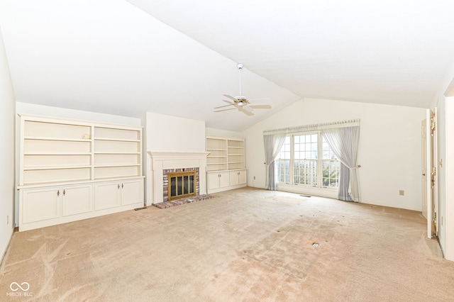 unfurnished living room featuring carpet flooring, a fireplace, a ceiling fan, and vaulted ceiling