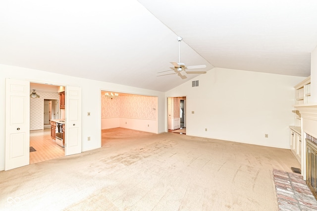 unfurnished living room featuring visible vents, light colored carpet, lofted ceiling, ceiling fan with notable chandelier, and a fireplace