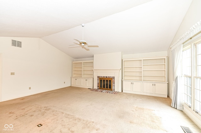 unfurnished living room featuring visible vents, lofted ceiling, light colored carpet, and a brick fireplace