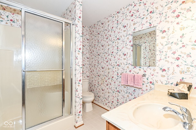 full bathroom featuring tile patterned flooring, wallpapered walls, toilet, a stall shower, and vanity