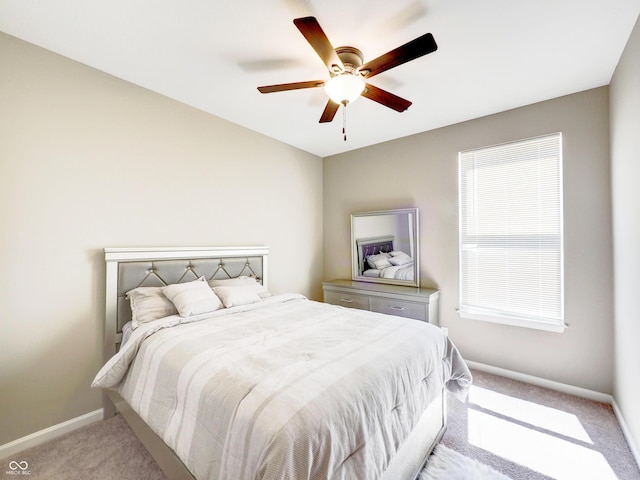 bedroom with baseboards, light colored carpet, and ceiling fan