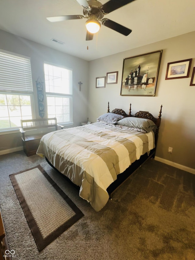 carpeted bedroom with visible vents, ceiling fan, and baseboards