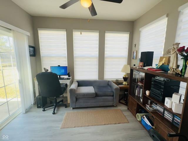 home office featuring light wood-style flooring and ceiling fan