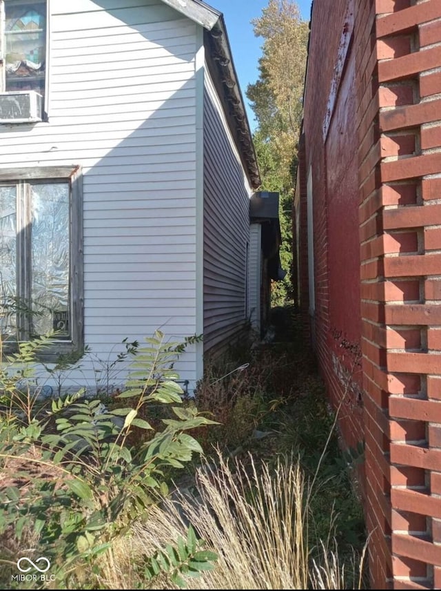 view of side of home featuring cooling unit