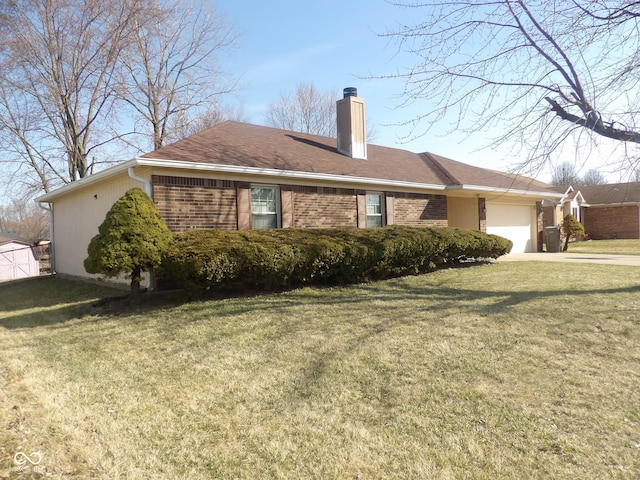 view of side of property featuring brick siding, a lawn, an attached garage, and a chimney