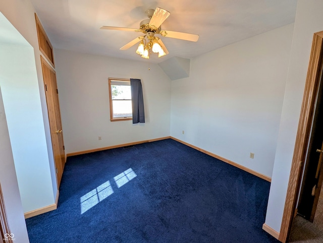 unfurnished bedroom with ceiling fan, baseboards, and dark colored carpet