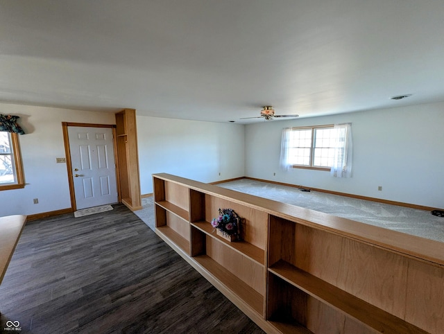 foyer with dark wood finished floors, a ceiling fan, and baseboards