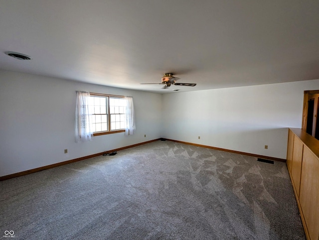 carpeted empty room featuring a ceiling fan, baseboards, and visible vents