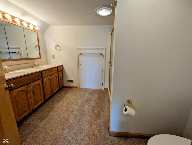 full bathroom with double vanity, visible vents, lofted ceiling, and a sink