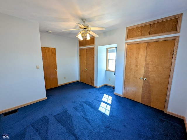 unfurnished bedroom featuring visible vents, ceiling fan, carpet, and baseboards