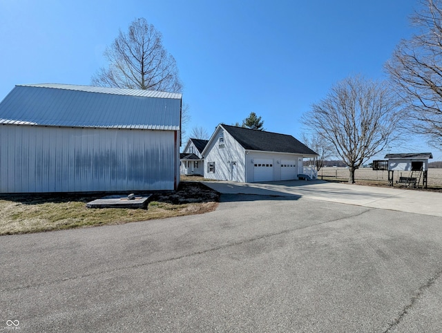 view of home's exterior with an outdoor structure and a garage