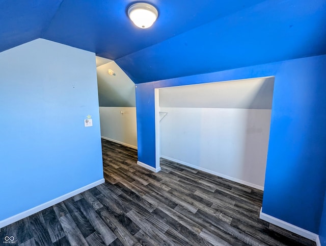 bonus room featuring baseboards, wood finished floors, and vaulted ceiling