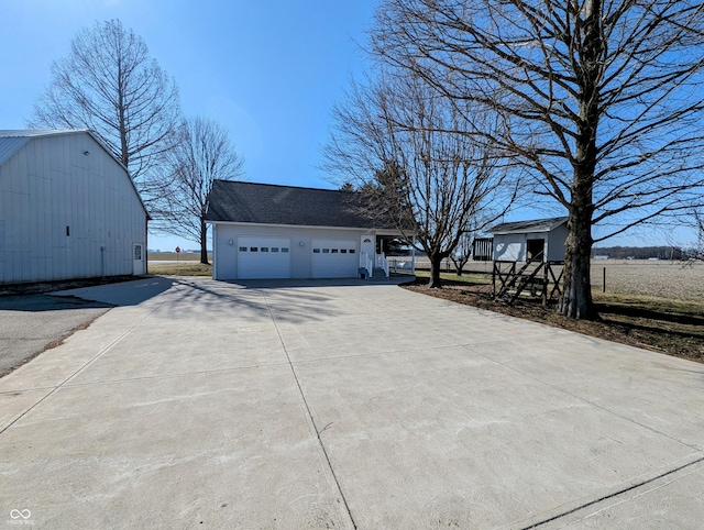 garage with concrete driveway