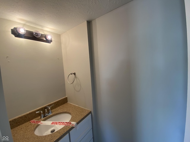 bathroom with vanity and a textured ceiling