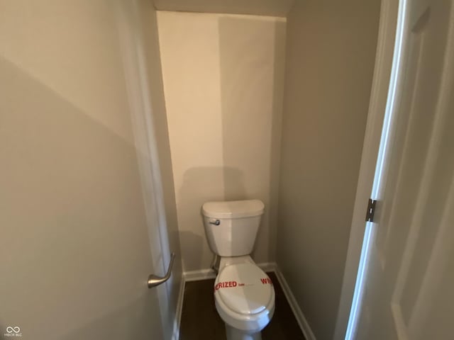 bathroom featuring toilet and baseboards