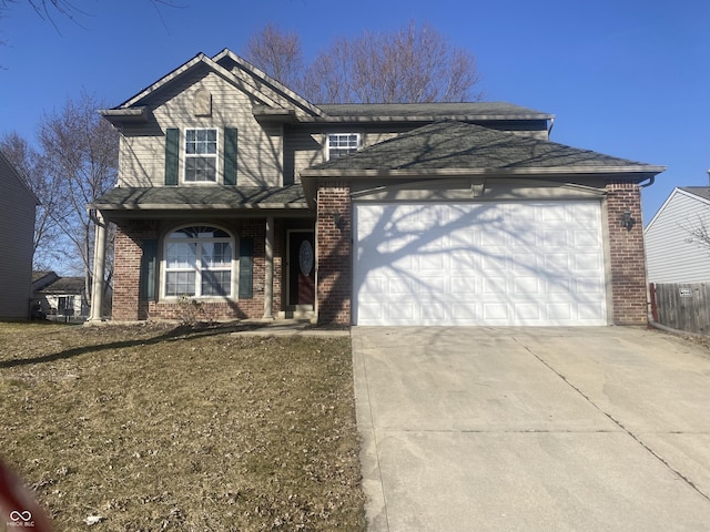 traditional-style house with brick siding, an attached garage, concrete driveway, and fence