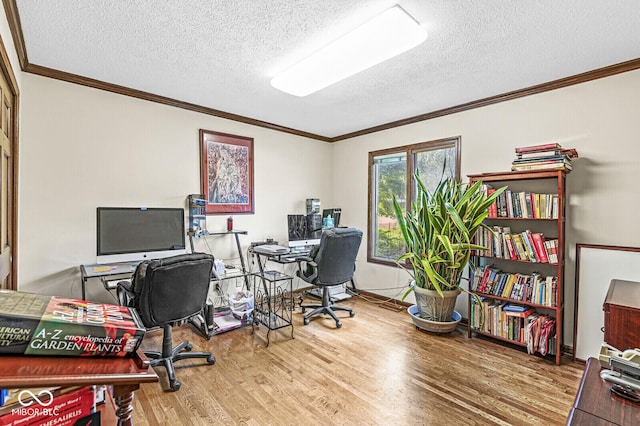 office space featuring a textured ceiling, crown molding, baseboards, and wood finished floors