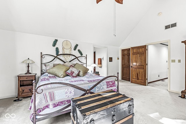 bedroom featuring visible vents, light carpet, high vaulted ceiling, and ceiling fan