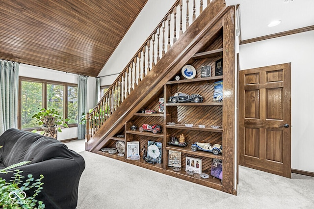 interior space featuring crown molding, wood ceiling, baseboards, and carpet floors