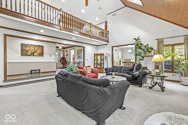 carpeted living area featuring recessed lighting, visible vents, ceiling fan with notable chandelier, and a high ceiling