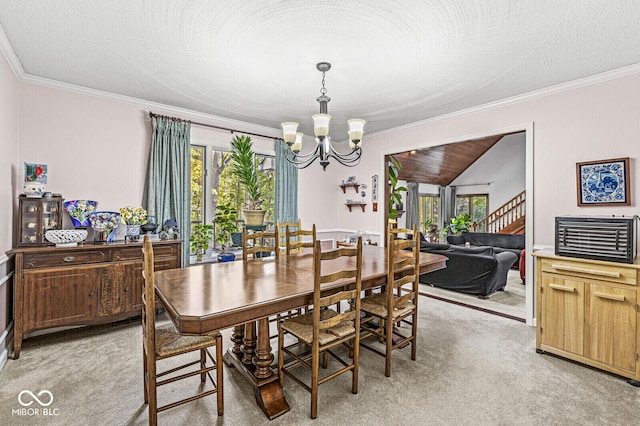 dining room featuring a textured ceiling, a notable chandelier, light colored carpet, and ornamental molding