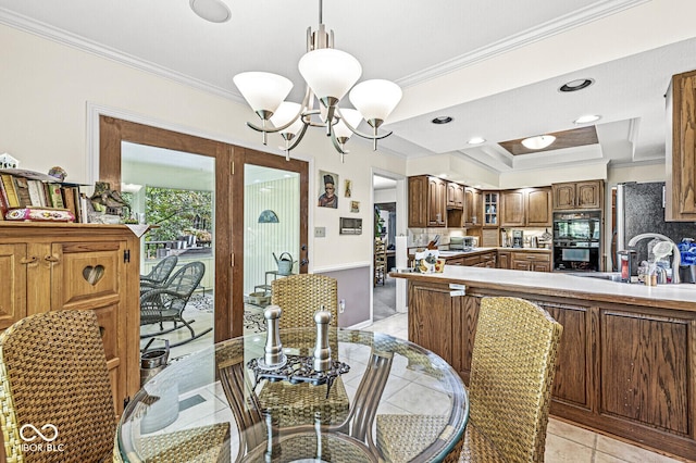 dining room with a raised ceiling, a notable chandelier, recessed lighting, and ornamental molding